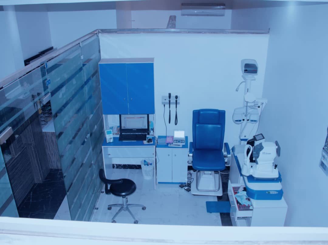 A view of an eye clinic in Abuja with a desk and chairs.