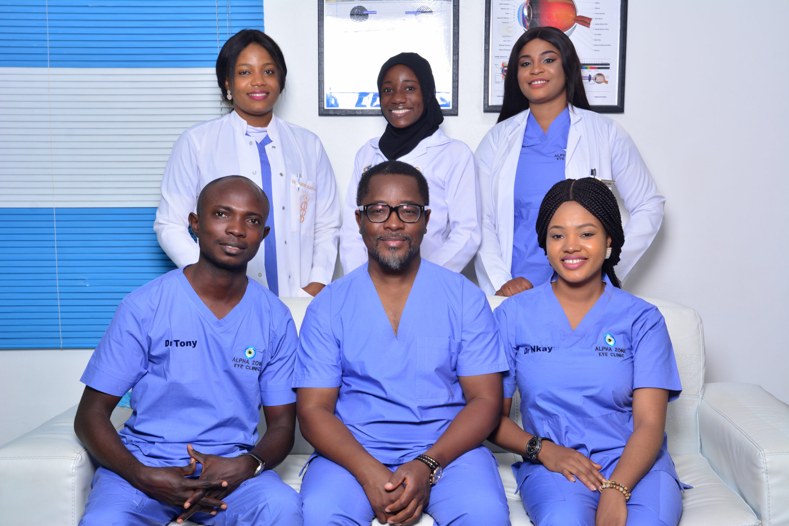 A group of people in blue scrubs posing for a photo at the best eye clinic in Abuja.