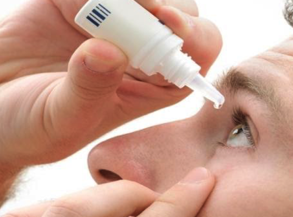 A man is applying an eye cream to his eye at an eye clinic in Abuja.